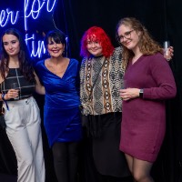 Group of three girls pose with President Mantella